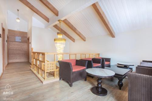 a living room with a table and chairs at Arco Hotels & Resorts sonamarg in Sonāmarg