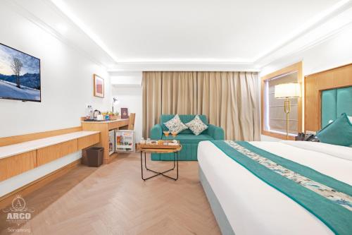 a hotel room with a bed and a chair at Arco Hotels & Resorts sonamarg in Sonāmarg