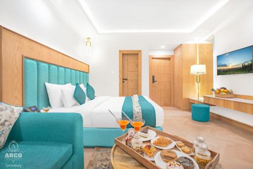 a hotel room with a bed and a table with food at Arco Hotels & Resorts sonamarg in Sonāmarg