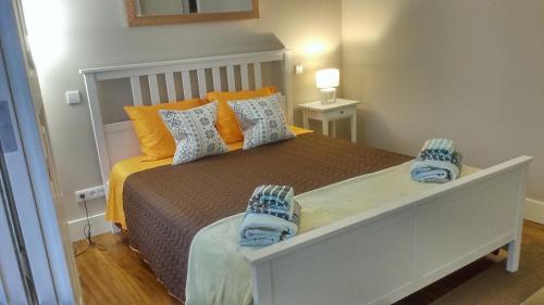 a bedroom with a bed with shoes on it at Trindade Apartment in Porto