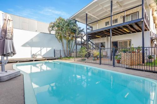 a swimming pool in front of a building at Pearl of Scarborough in Scarborough