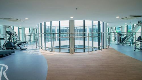 a gym with treadmills and exercise equipment in a building at Republic Plaza Airpot Tân Sơn Nhất view sân bay in Ho Chi Minh City