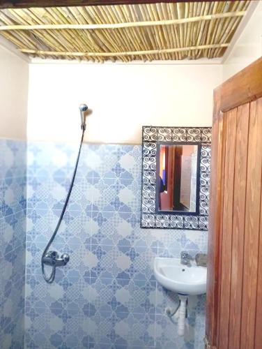a bathroom with a sink and a mirror at Dar INNÂ in Aït Benhaddou
