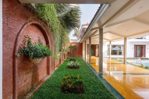an internal courtyard of a house with plants at Ananta Vilas by StayJadeLuxuriousPrivate Pool in Kumbalgod
