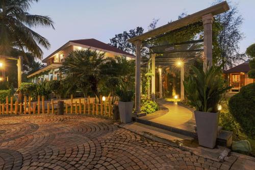 a house with a pavilion in front of a brick driveway at Ananta Vilas by StayJadeLuxuriousPrivate Pool in Kumbalgod