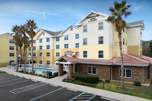 an exterior view of a hotel with a parking lot at TownePlace Suites Pensacola in Pensacola