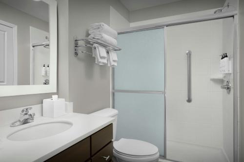 a bathroom with a shower and a toilet and a sink at TownePlace Suites Pensacola in Pensacola