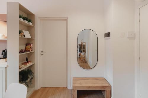 a hallway with a mirror and a wooden table at Bilo e Mono a 2 passi dall'Ospedale, Centro e Stazione - CasaP17 in Varese