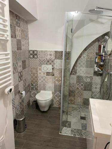 a bathroom with a toilet and a glass shower at Charm and comfort in Via Eraclea in Bernalda