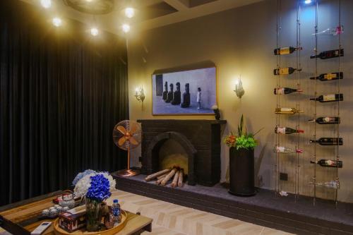 a living room with a fireplace and a table at Ecopark Duplex Homestay by QMP in HÆ°ng YÃªn