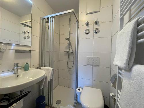 a bathroom with a shower and a toilet and a sink at Ferienwohnung Sonnenglück in Schönau am Königssee