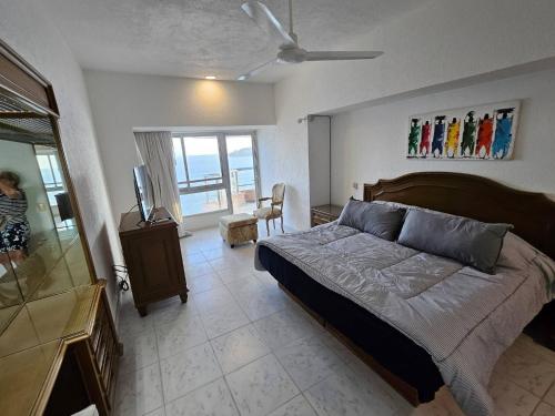 a bedroom with a bed and a television in it at Tropical Paradise Getaway in Acapulco with Private Infinity Pool in Acapulco