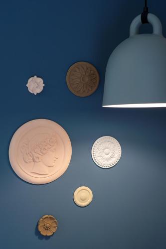 a blue wall with several different plates on it at Topos Villas in Parga