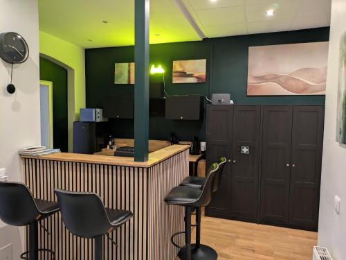 a barbershop with black chairs and a green wall at Munich large Apartment 110 qm in very cetral location 1 to 12 Guests in Munich
