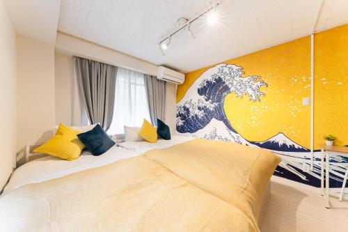a bedroom with a wave mural on the wall at Japanese Art Room, 2Bed Room, 4Bed, Near Metro&JR station in Tokyo