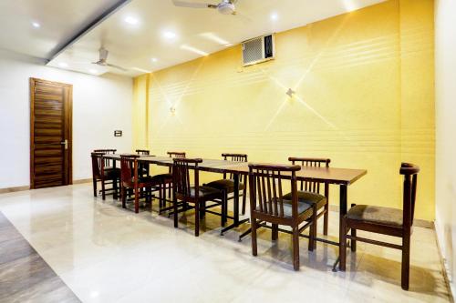 a dining room with a long table and chairs at Super Collection O Amritsar Near Bus Stand in Amritsar