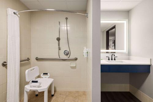 a bathroom with a toilet and a sink at AmericInn by Wyndham Lincoln South in Lincoln