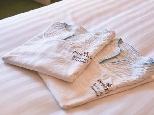 two towels sitting on top of a bed at Dorsett by Agora Osaka Sakai in Sakai