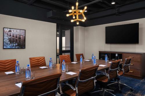 a conference room with a long table and chairs at The Well House Hamilton, Tapestry Collection By Hilton in Hamilton