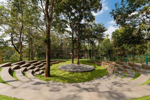 an amphitheatre in a park with trees and grass at Morickap Lord's 83, Trademark Collection by Wyndham in Meenangadi