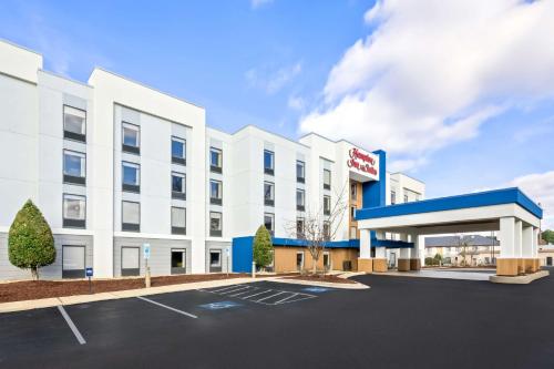 an image of a hotel building with a gas station at Hampton Inn & Suites Wilson I-95 in Wilson