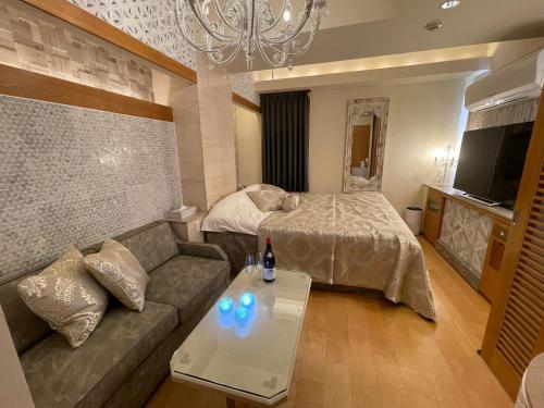Postel nebo postele na pokoji v ubytování hotel evi tower 大人専用