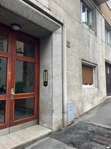 a building with a wooden door and a window at Ursich casa studio in Trieste