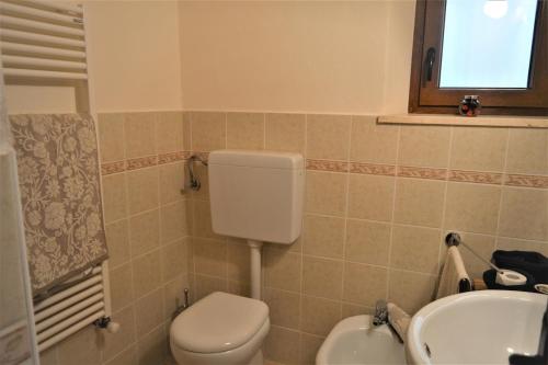 a bathroom with a toilet and a sink at Bellavista apartment in Bagni di Lucca