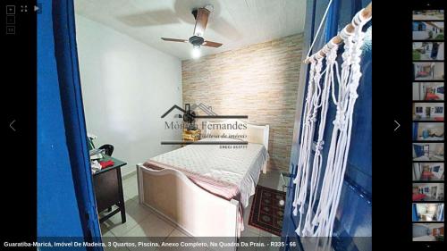 a bedroom with a bed and a brick wall at 50 metros da praia - pé na areia in Maricá
