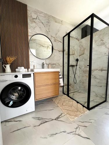 a bathroom with a washing machine and a shower at Meldaria Residence in Krk