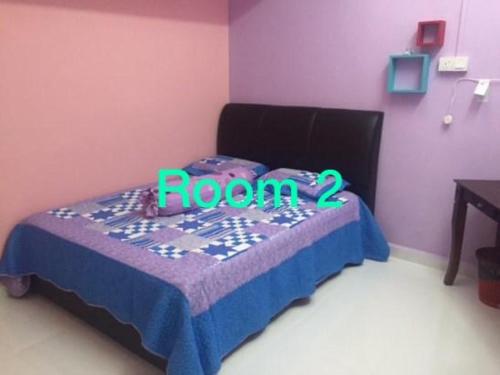 a bedroom with a bed with a room sign on it at Dfieza Homestay Chukai in Cukai