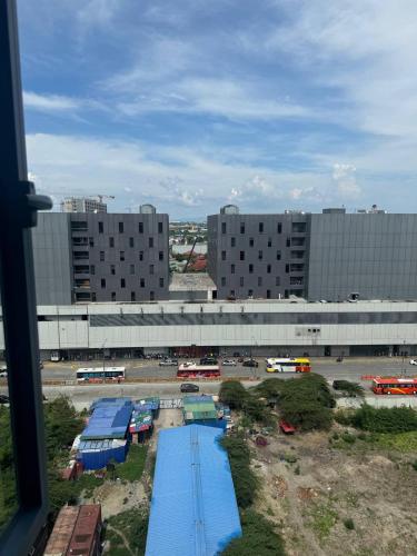 a view of a parking lot with buses and buildings at LCONDOTEL Hotel Studio with Balcony at Imperial Plaza near MOA NAIA PITX in Manila