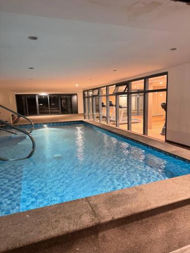 a large swimming pool in a building at LCONDOTEL Hotel Studio with Balcony at Imperial Plaza near MOA NAIA PITX in Manila