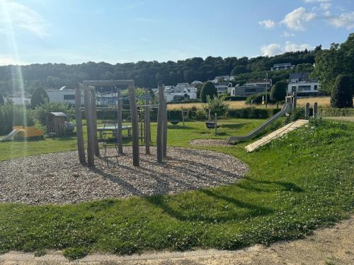 a playground with a slide in a park at Appartement NEUF, 6 personnes, 2 chambres in Ohligsmühle
