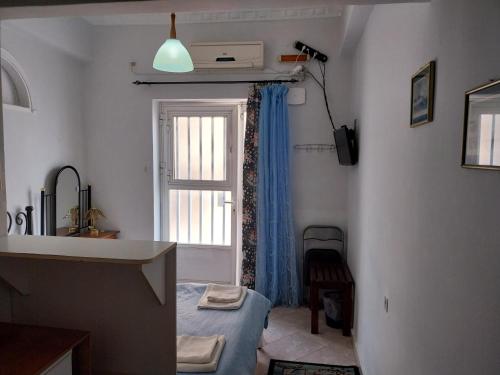 Postel nebo postele na pokoji v ubytování HERMOUPOLI ROOMS