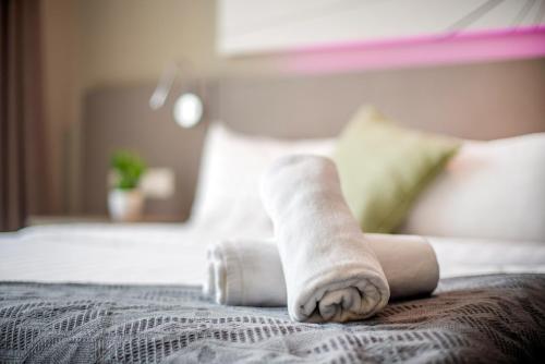 a rolled up towel on top of a bed at Empire Damansara Petaling Jaya by COBNB in Petaling Jaya