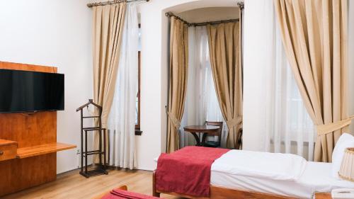 a hotel room with a bed and a flat screen tv at Istanbul Irish Hotel in Istanbul
