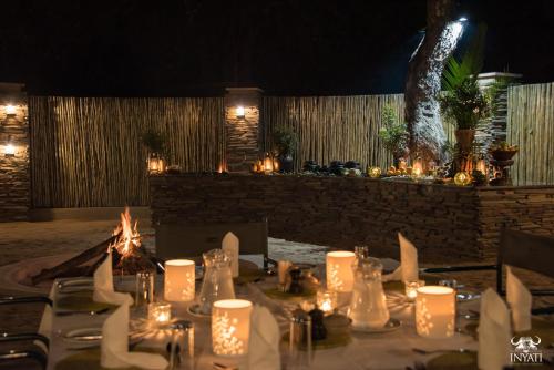 a table set up for a wedding with candles at Inyati Game Lodge in Sabi Sand Game Reserve