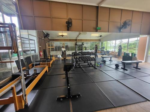 a gym with a lot of equipment and people in it at Casa Sakhu Beach Villa Phuket in Nai Yang Beach