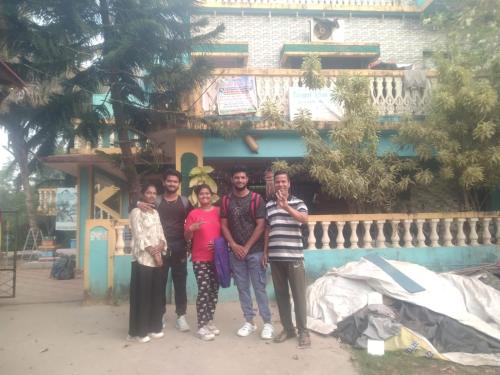 a group of people standing in front of a building at NISARG HOME STAY near Bus Stand Malvan in Malvan