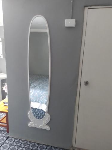 a mirror hanging on a wall in a room at Home Away From Home in Nadi