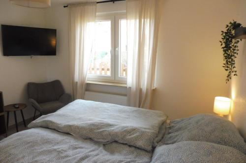 a bedroom with a bed and a window at Ferienhaus Marienhafe in Marienhafe