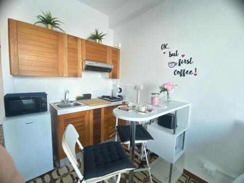 a small kitchen with a small table and a sink at TaorminaCentre Panorama in Taormina