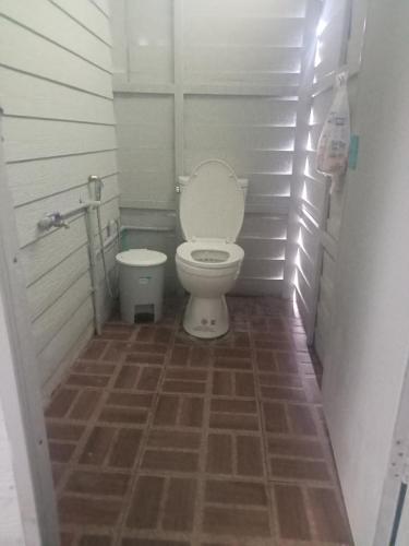 a small bathroom with a toilet in a stall at Kohmook treehouse in Kantang