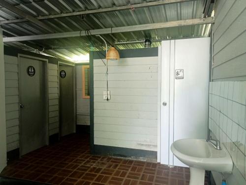 a bathroom with a sink and a toilet in it at Kohmook treehouse in Kantang