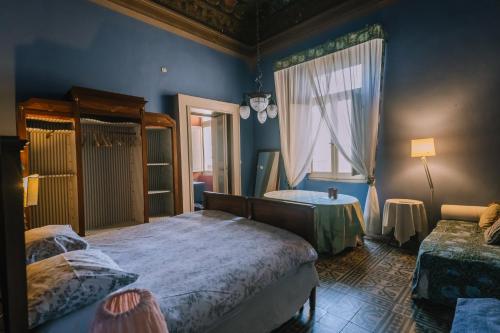 a bedroom with two beds and a window at Palazzo Romani Adami in Fermo