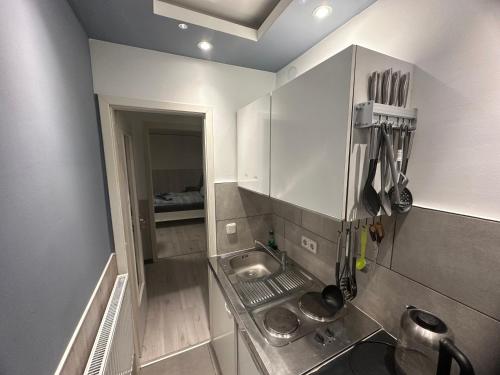 a small kitchen with a sink in a room at Haus Seefalke - 250 m zum Meer in Cuxhaven