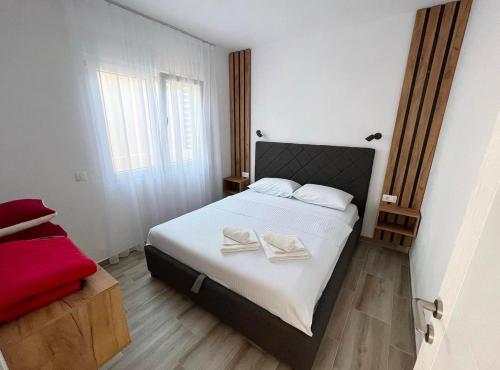 a bedroom with a bed with two towels on it at Apartment Complex with Pool in Bar, Montenegro in Bar