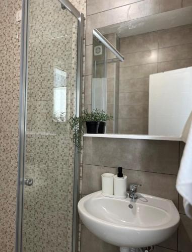 a bathroom with a sink and a shower at Apartment Complex with Pool in Bar, Montenegro in Bar
