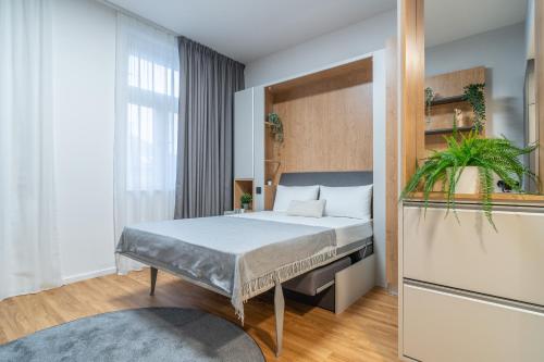 a bedroom with a bed and a large window at City Pop 2Night Prague - Self check-in in Prague